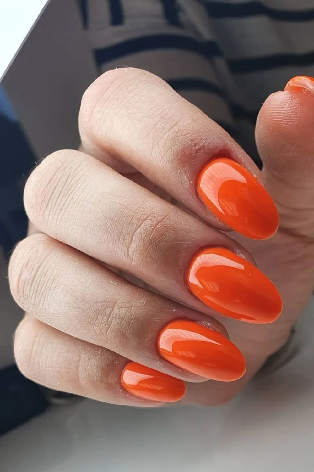 mandarine nails with a glossy finish.