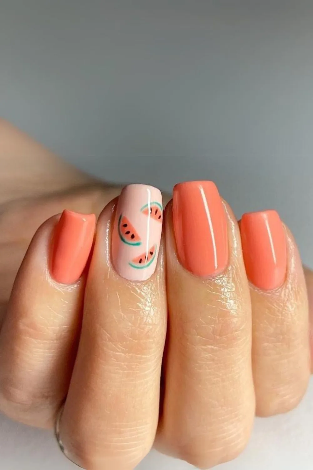 coral nails with watermelon accents