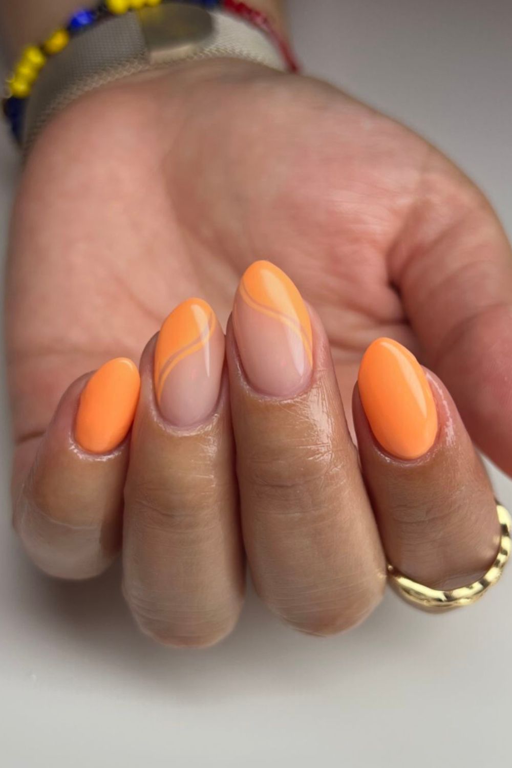 peach orange nails with wavy accent lines