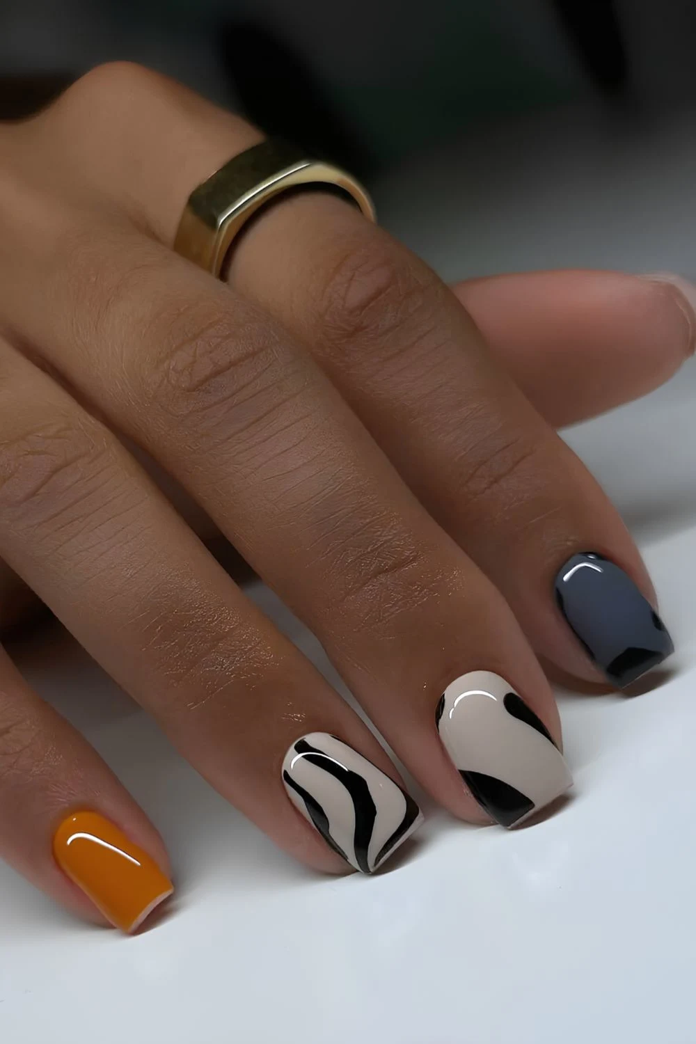 Artsy animal print nails in orange and grey