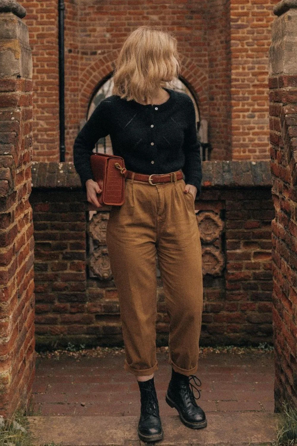 Black cardigan with high-waisted tan pants