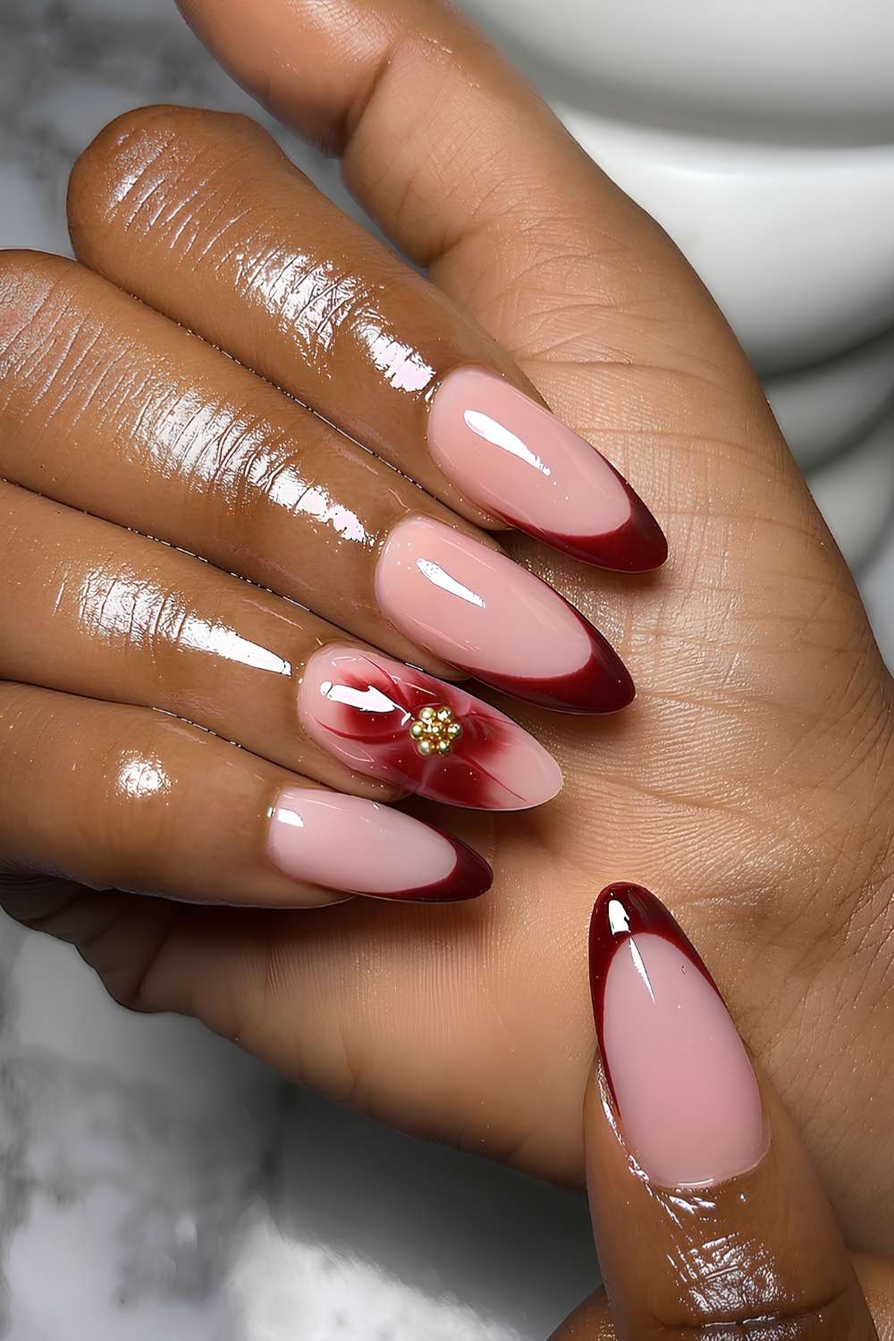 Burgundy French nails with blooming gel flower accent