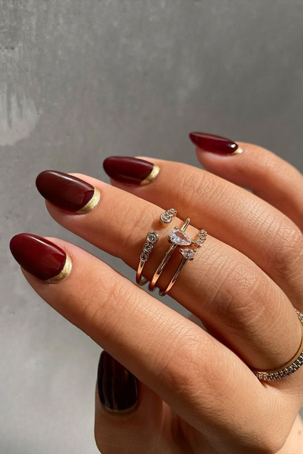 Burgundy nails with gold cuffs