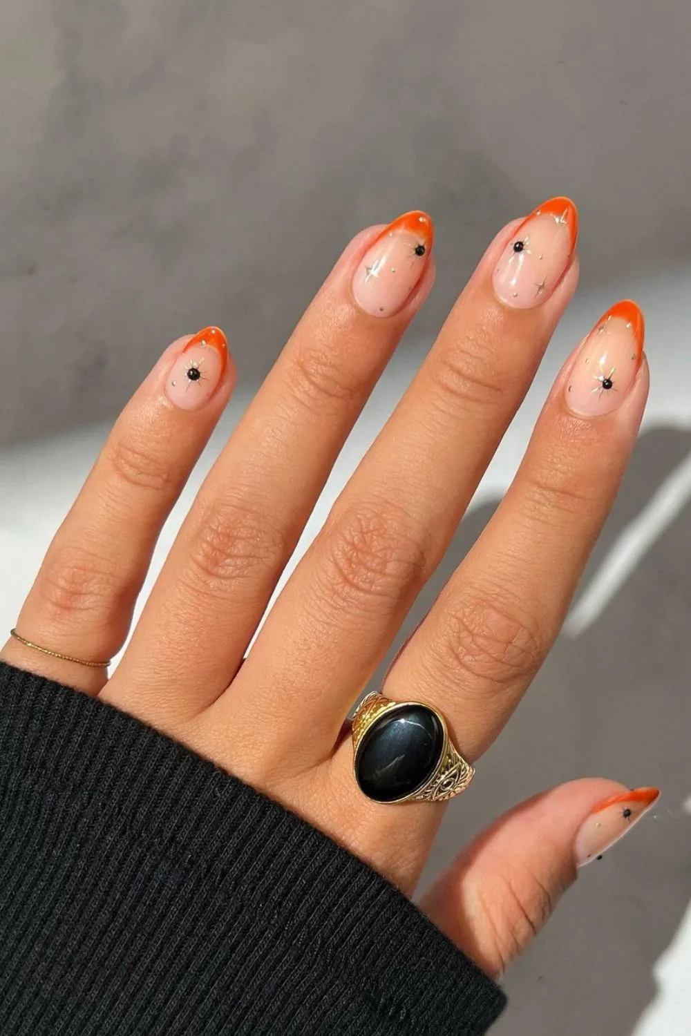 Burnt orange French tip nails with star accents