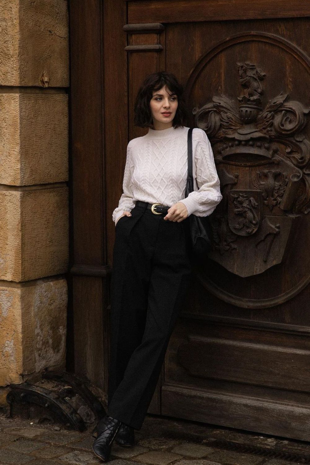 Cable-knit sweater and high-waisted trousers