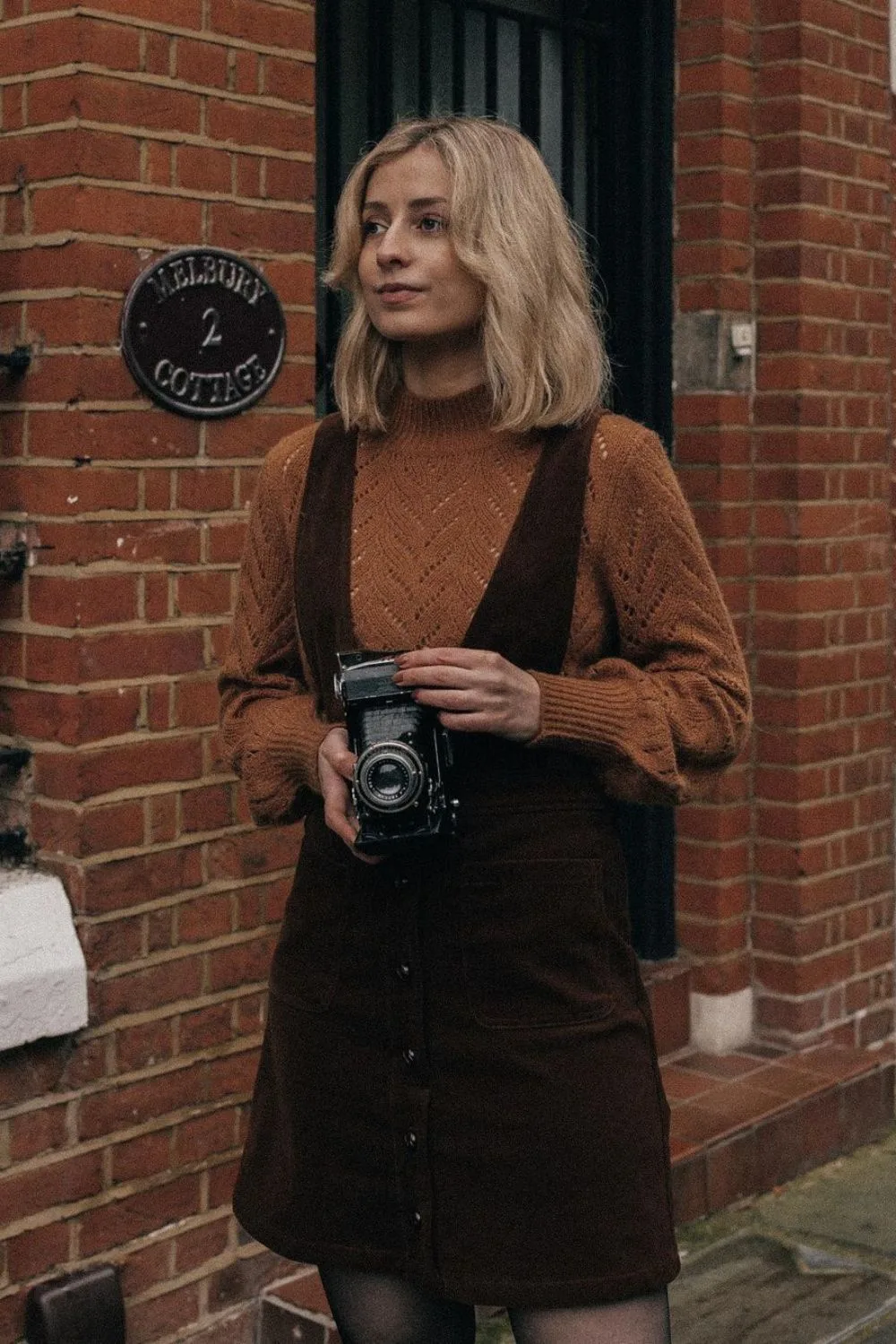 Cable knit sweater with corduroy pinafore