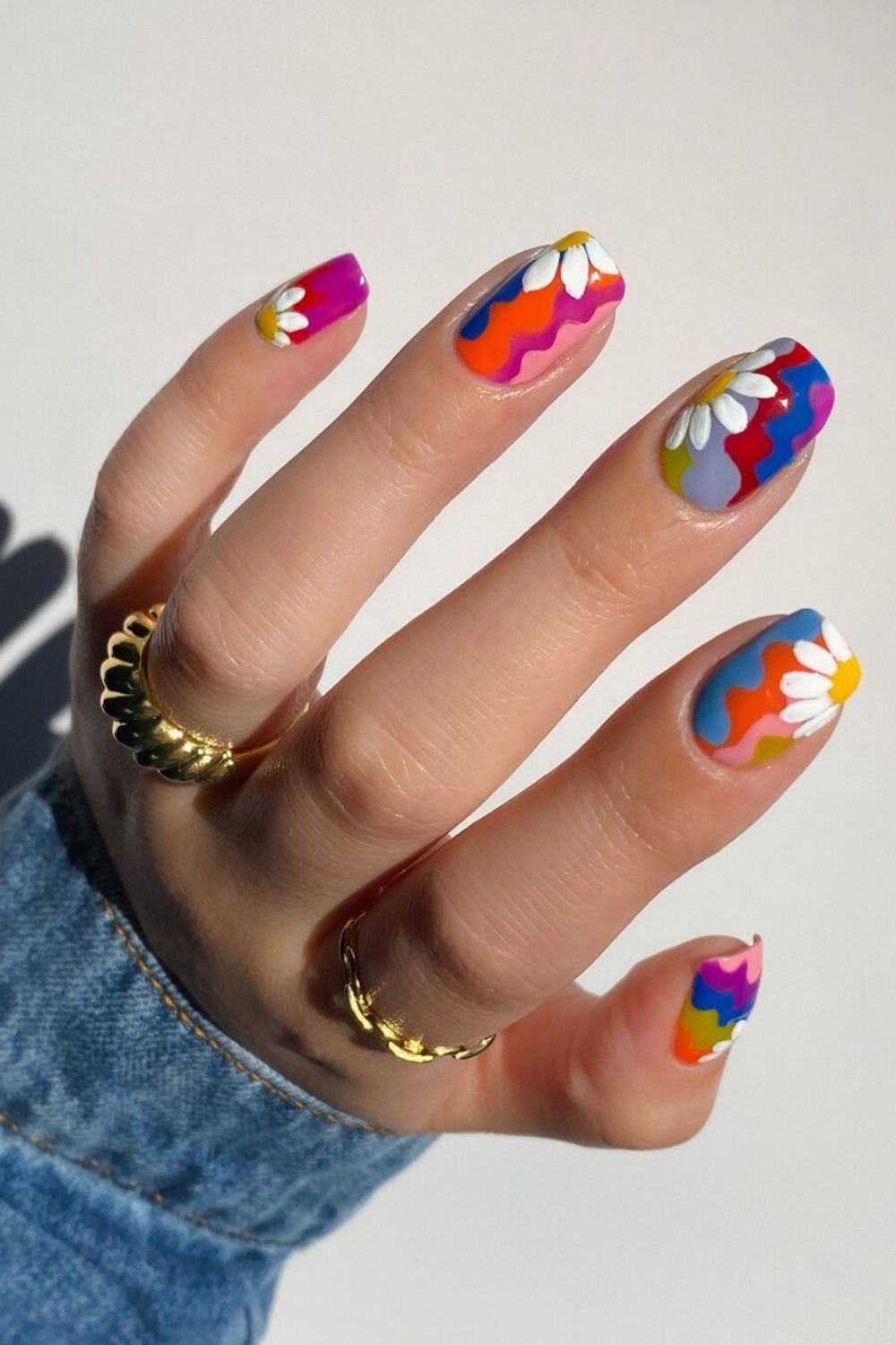 Colorful nails with daisy accents