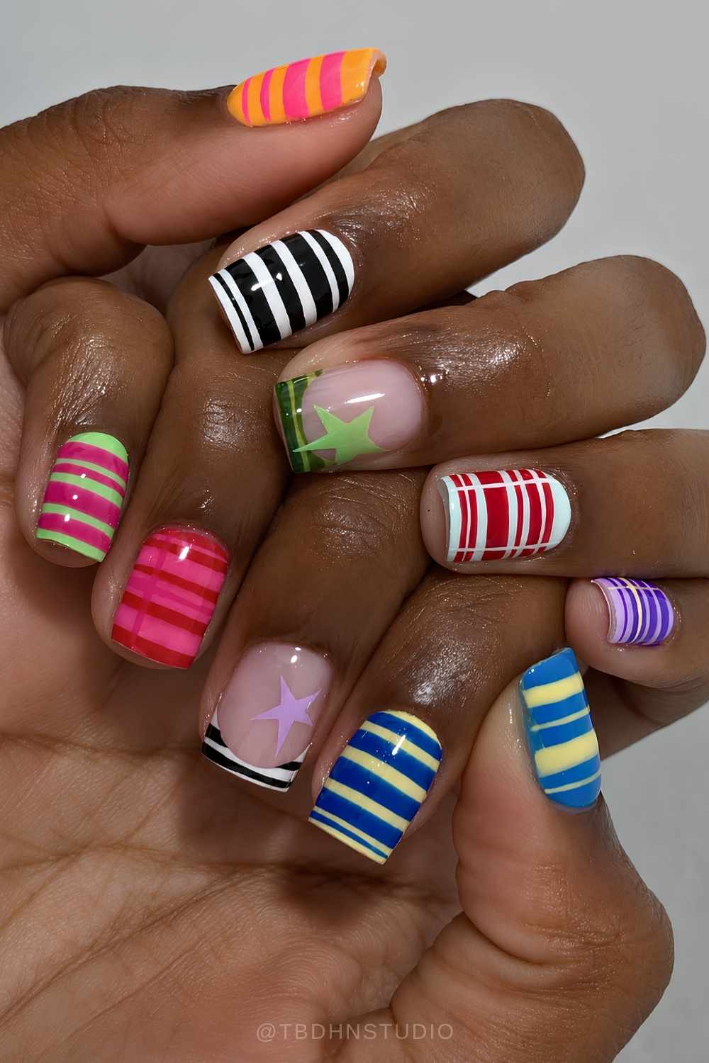 Colorful short striped nails with star accents