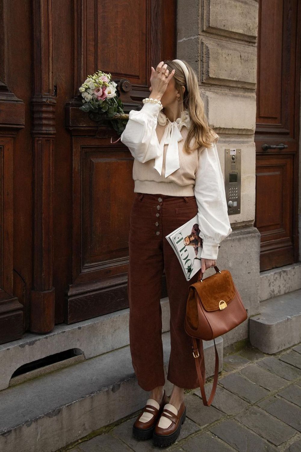 Cropped brown trousers with puff sleeve blouse and knit vest