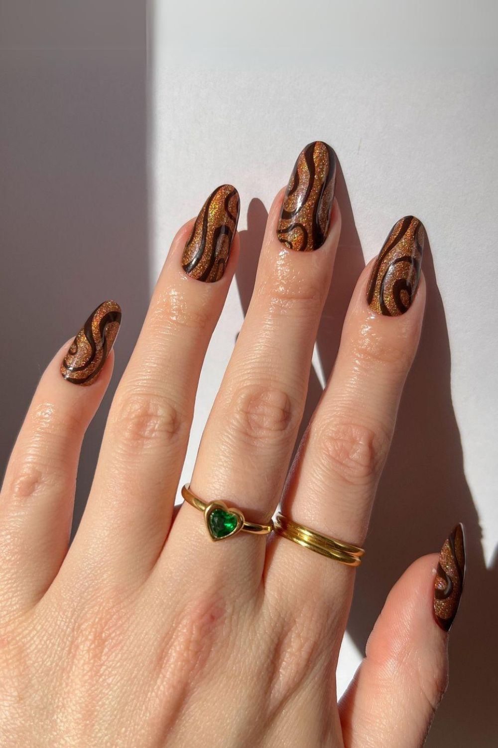 Glittery brown nails with swirls