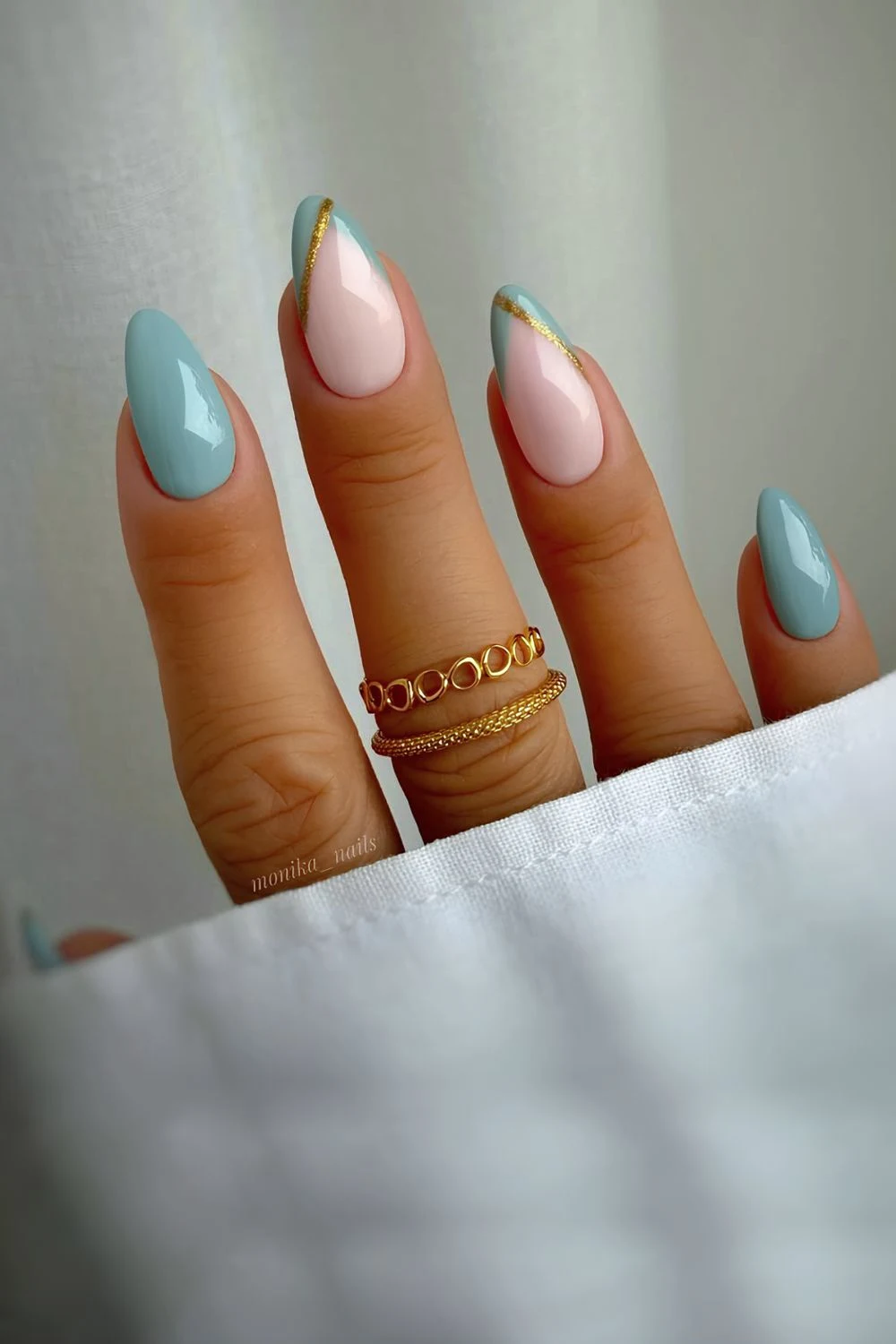 Greenish-blue solid and pointed french tips with gold glitter line accents