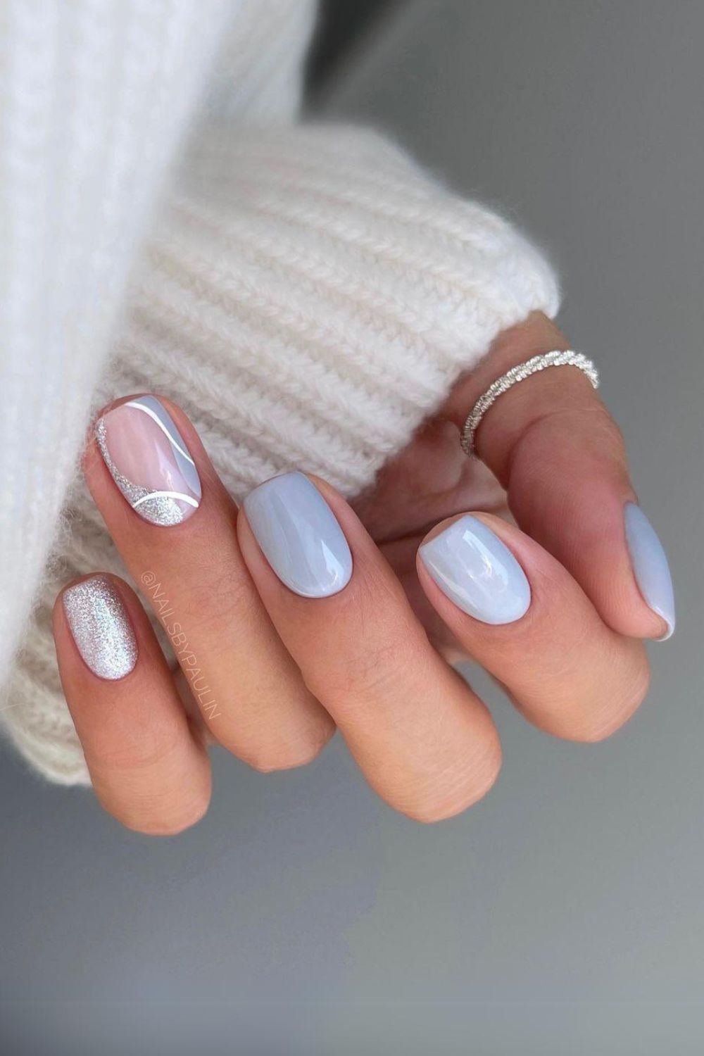 Light gray nails with glitter accents