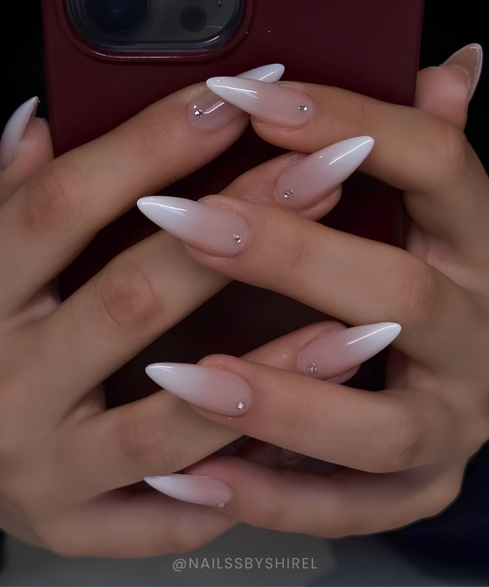 Long almond white ombre nails with gems