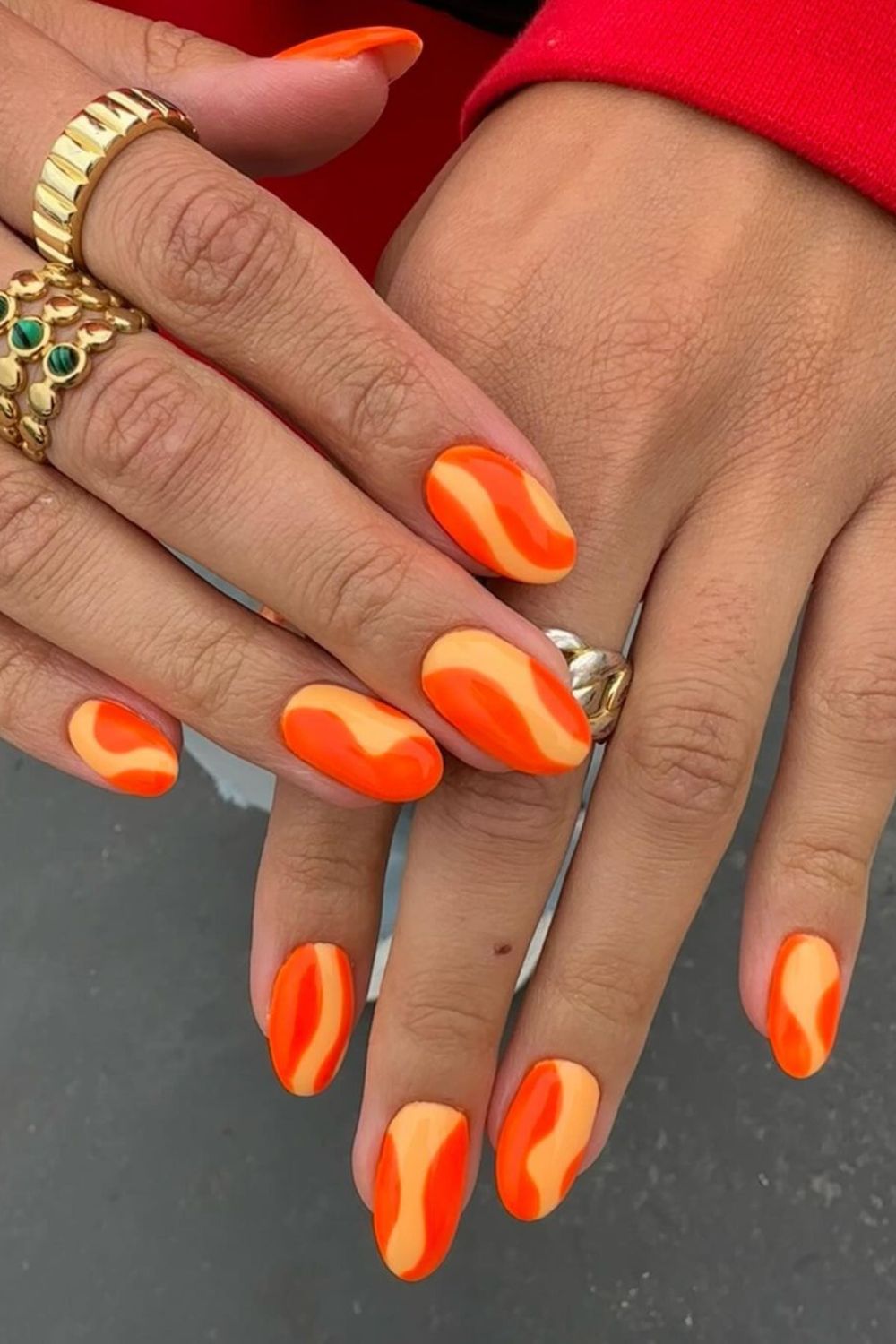 Nails with bright orange swirls