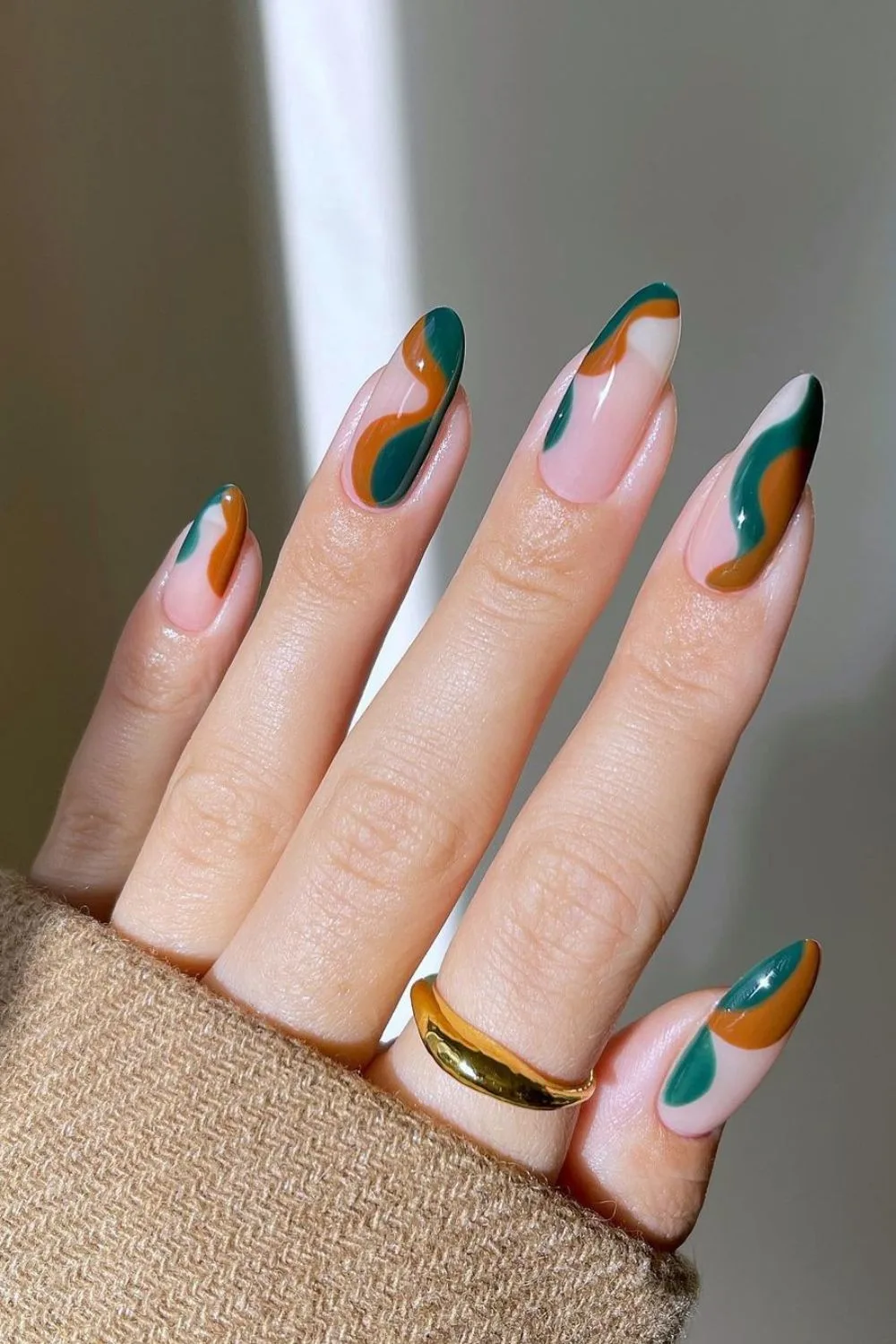 Nails with funky brown and green swirls