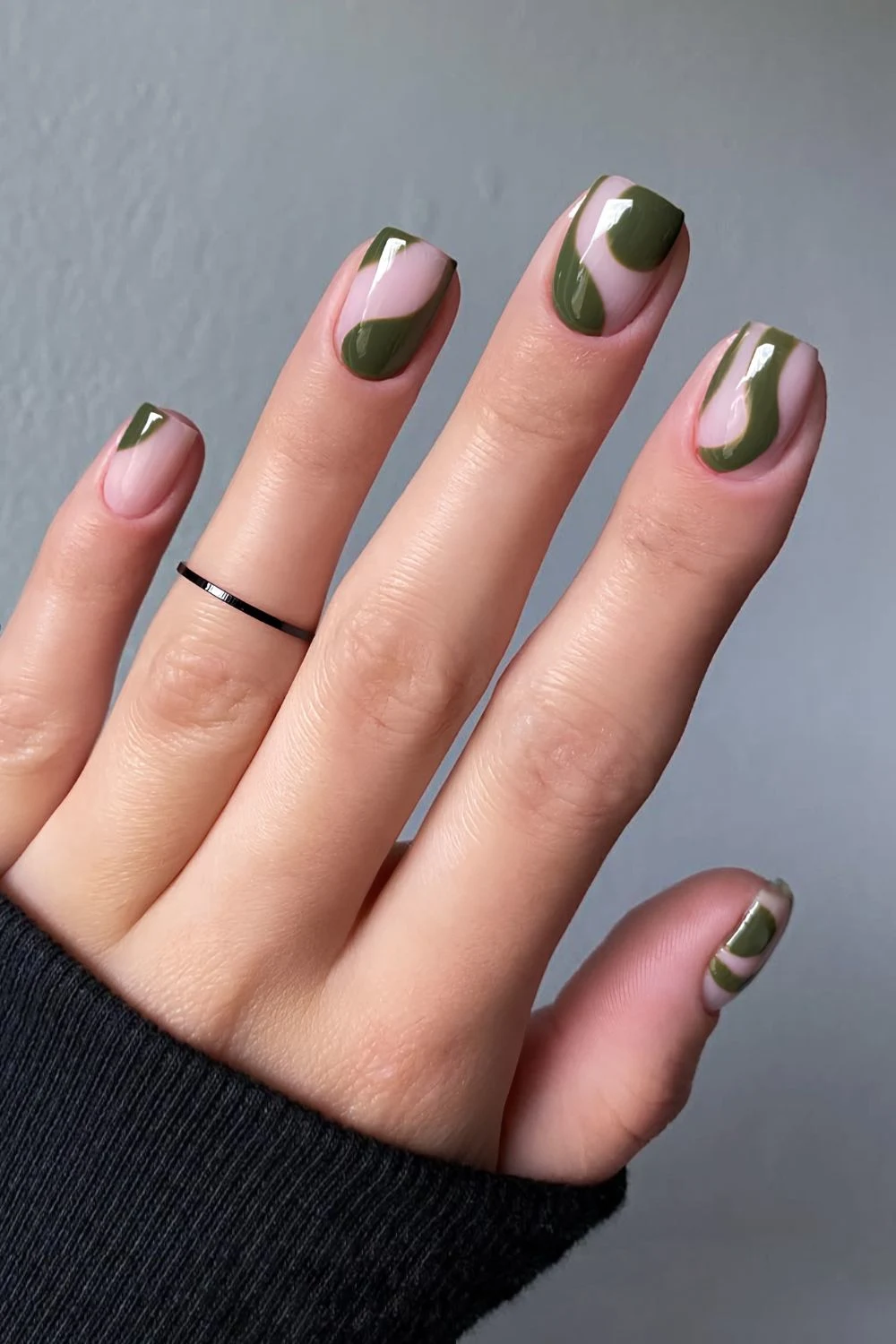 Neutral nails with abstract green swirls