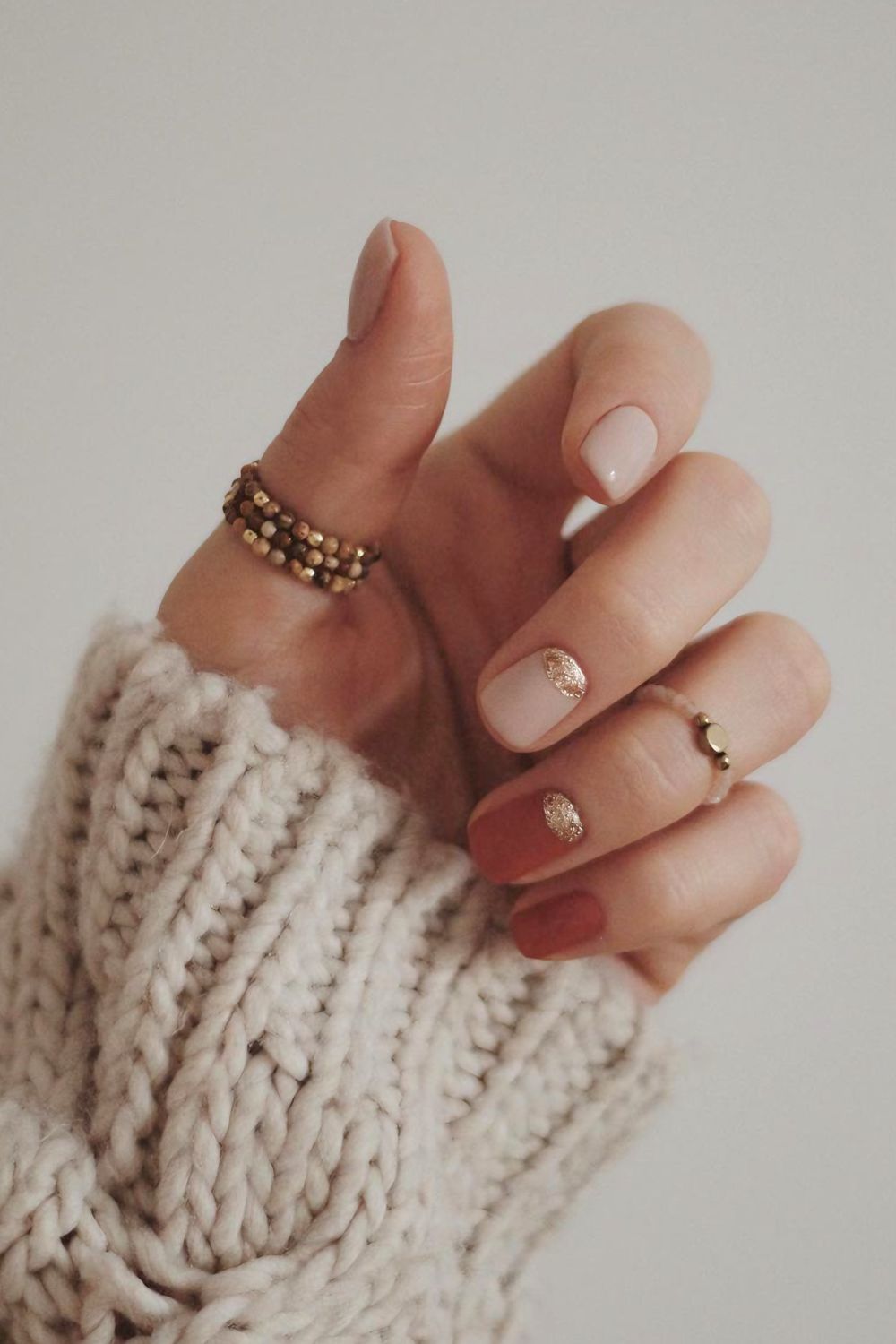 Nude and terracotta nails with gold cuffs