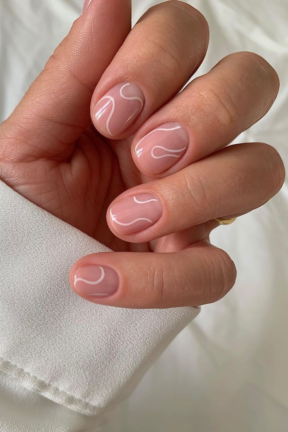 Nude nails with abstract white lines