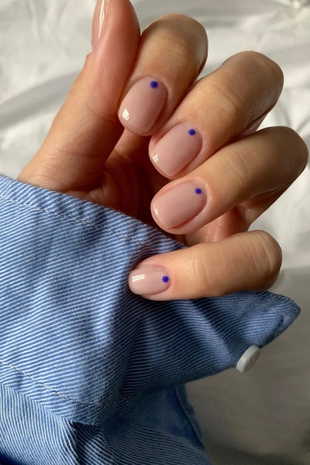 Nude nails with blue dot accents