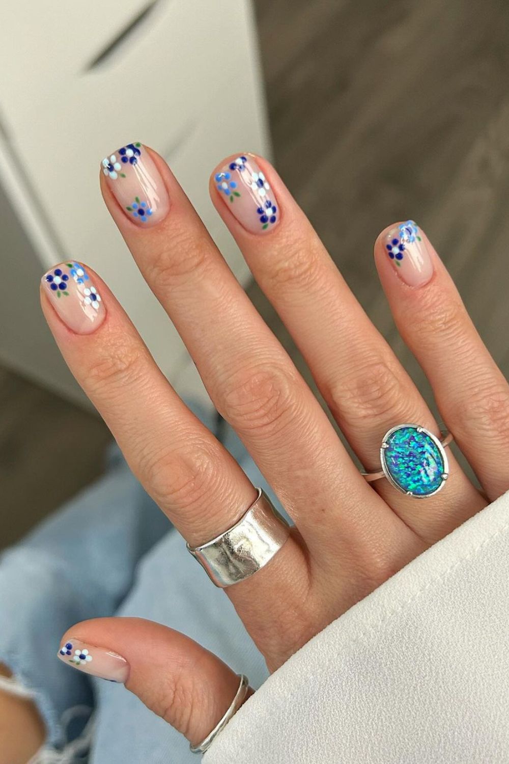 Nude nails with blue flowers