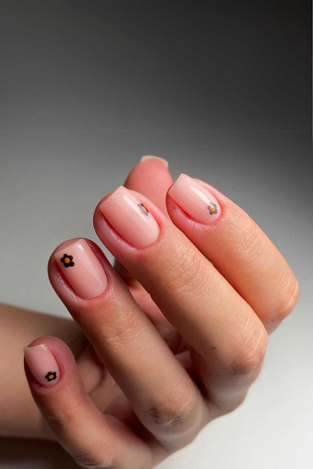 Nude nails with delicate flower accents