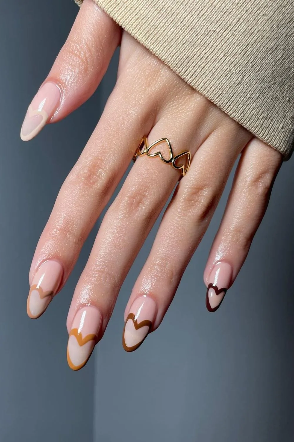 Nude nails with heart accent tips in fall colors