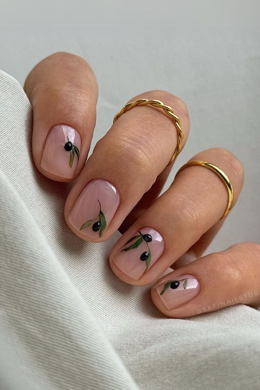 Nude nails with olive branch art