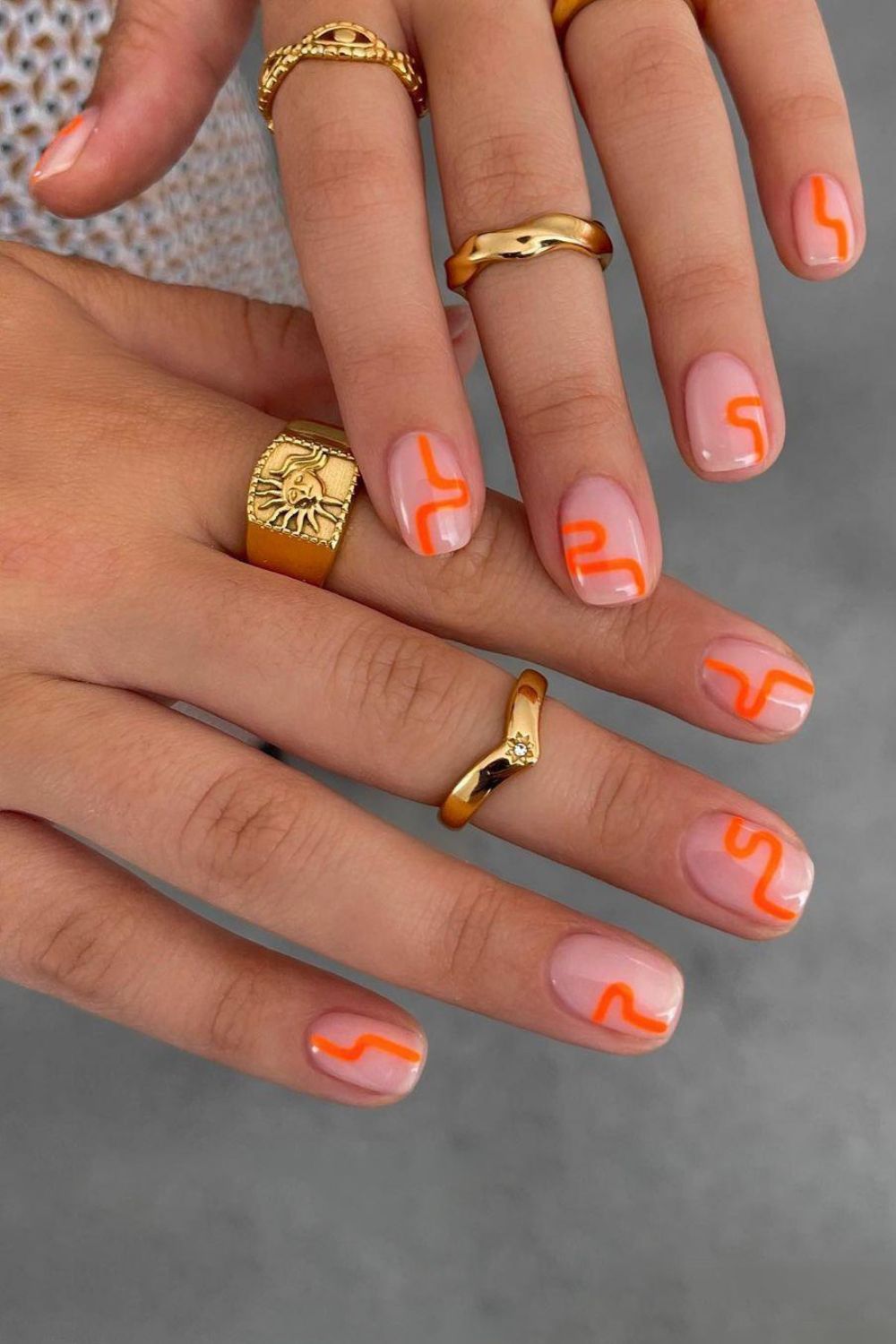 Nude nails with orange squiggles