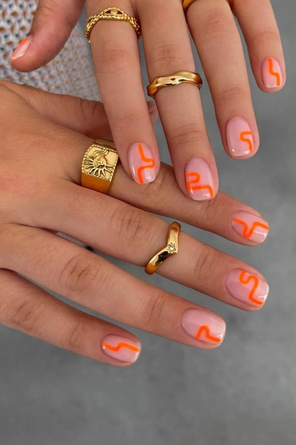 Nude nails with orange squiggles