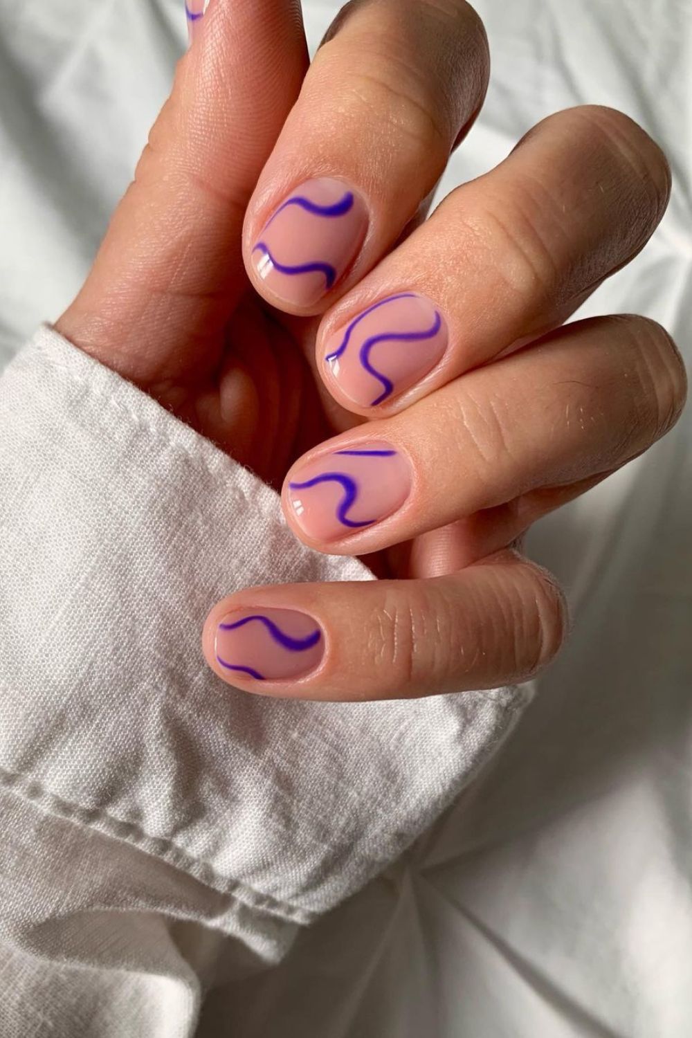 Nude nails with purple squiggles