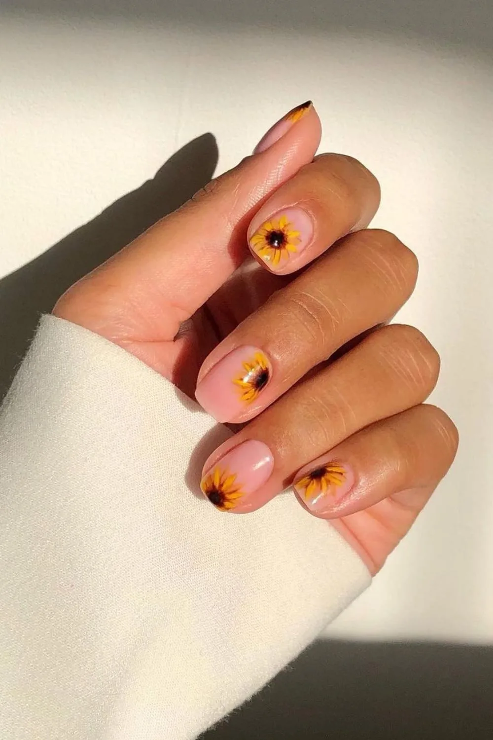 Nude nails with sunflower designs