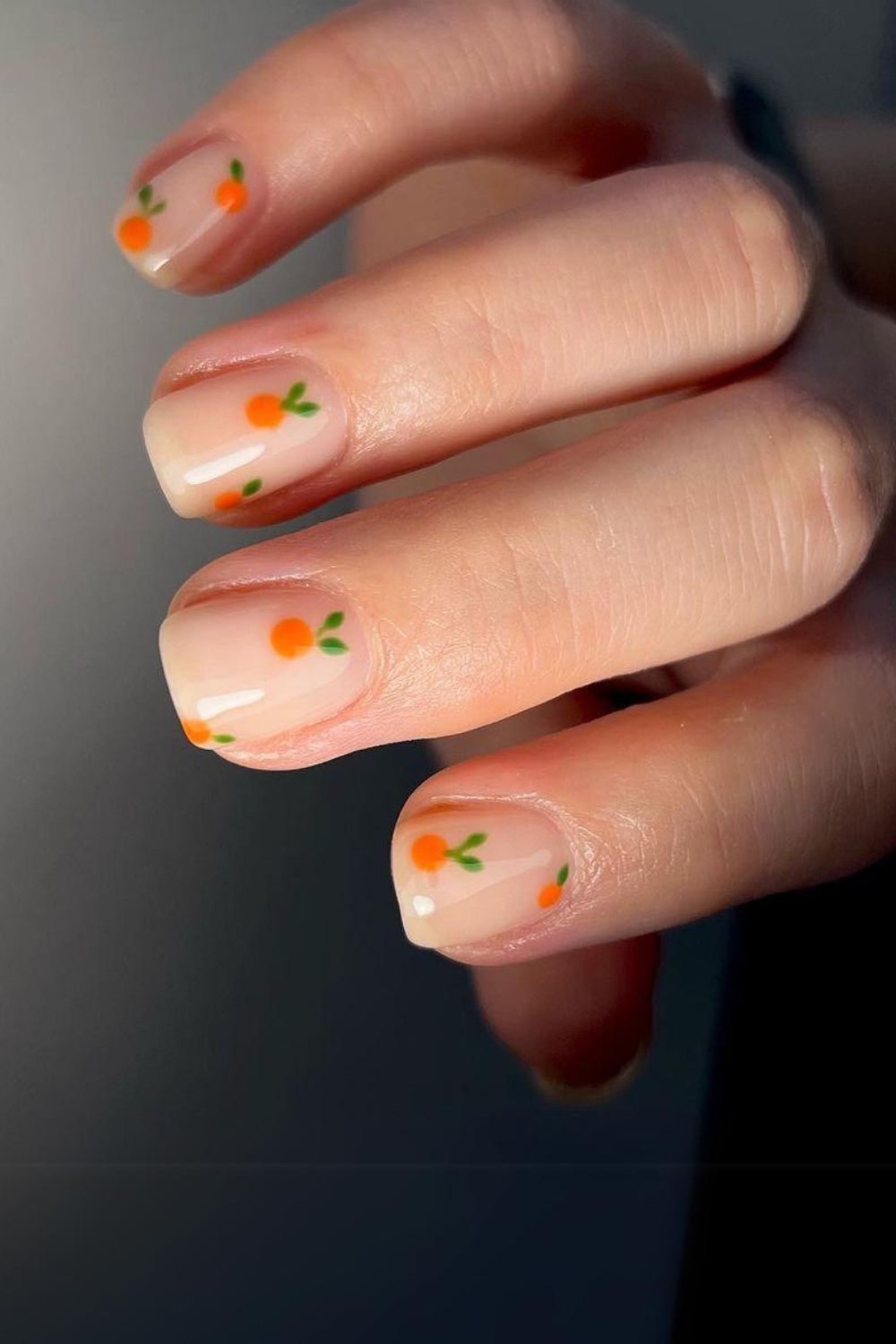 Nude nails with tiny orange accents