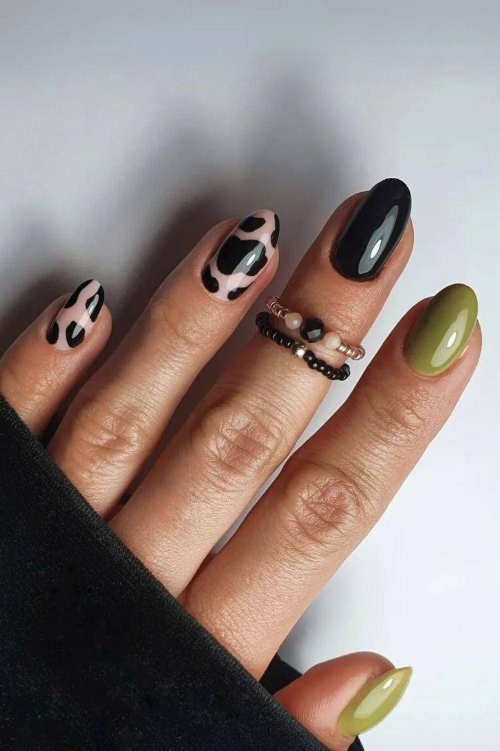 Olive green and black nails with cow print