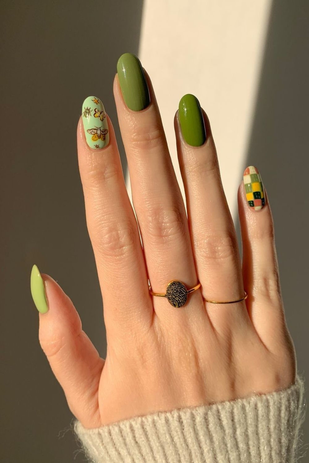 Olive green nails with butterflies and checkerboards