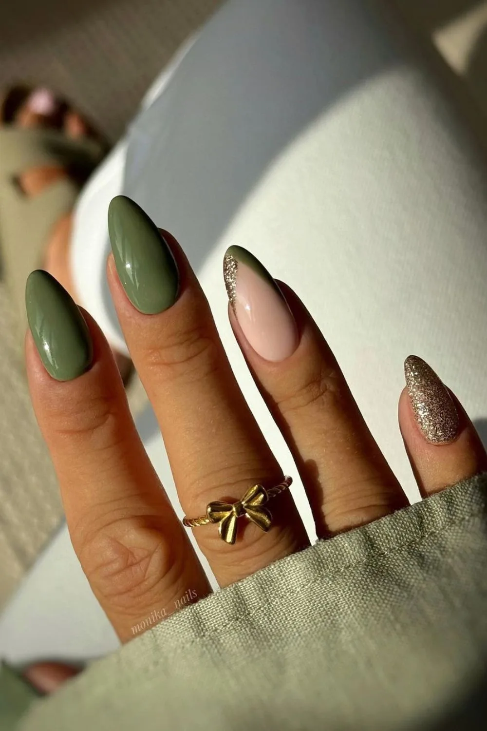 Olive green nails with glitter accents