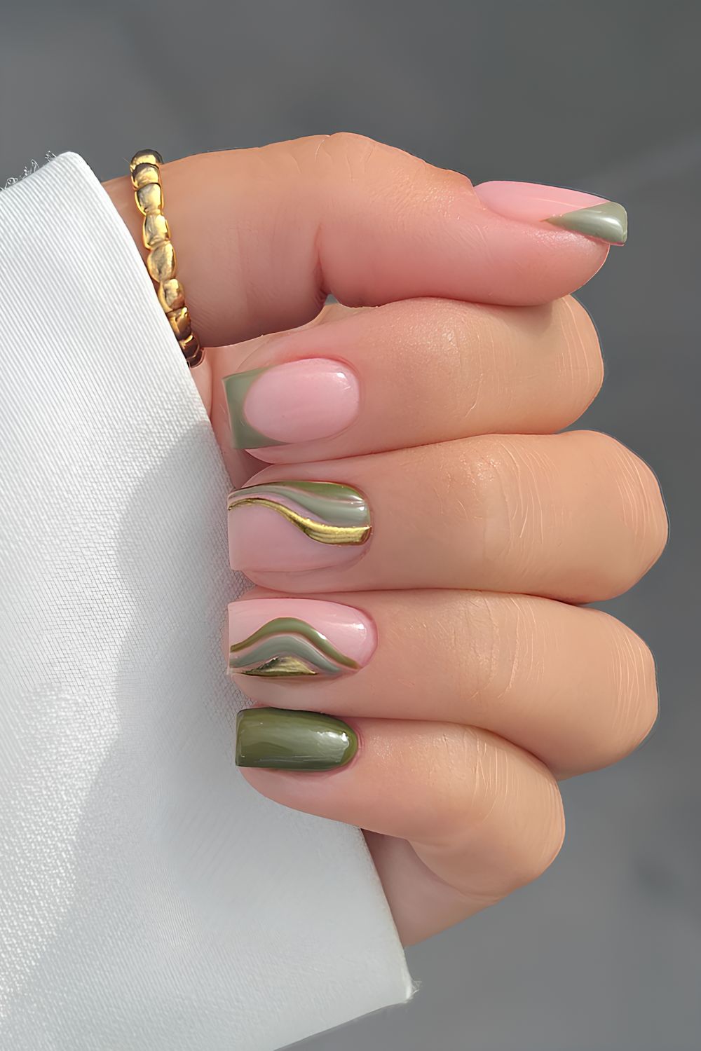 Olive green nails with metallic swirls