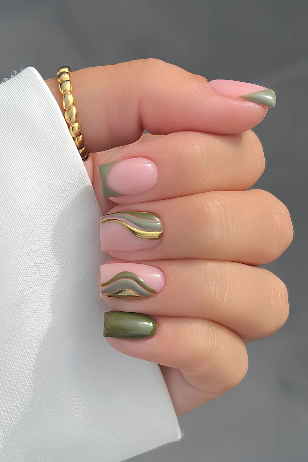 Olive green nails with metallic swirls