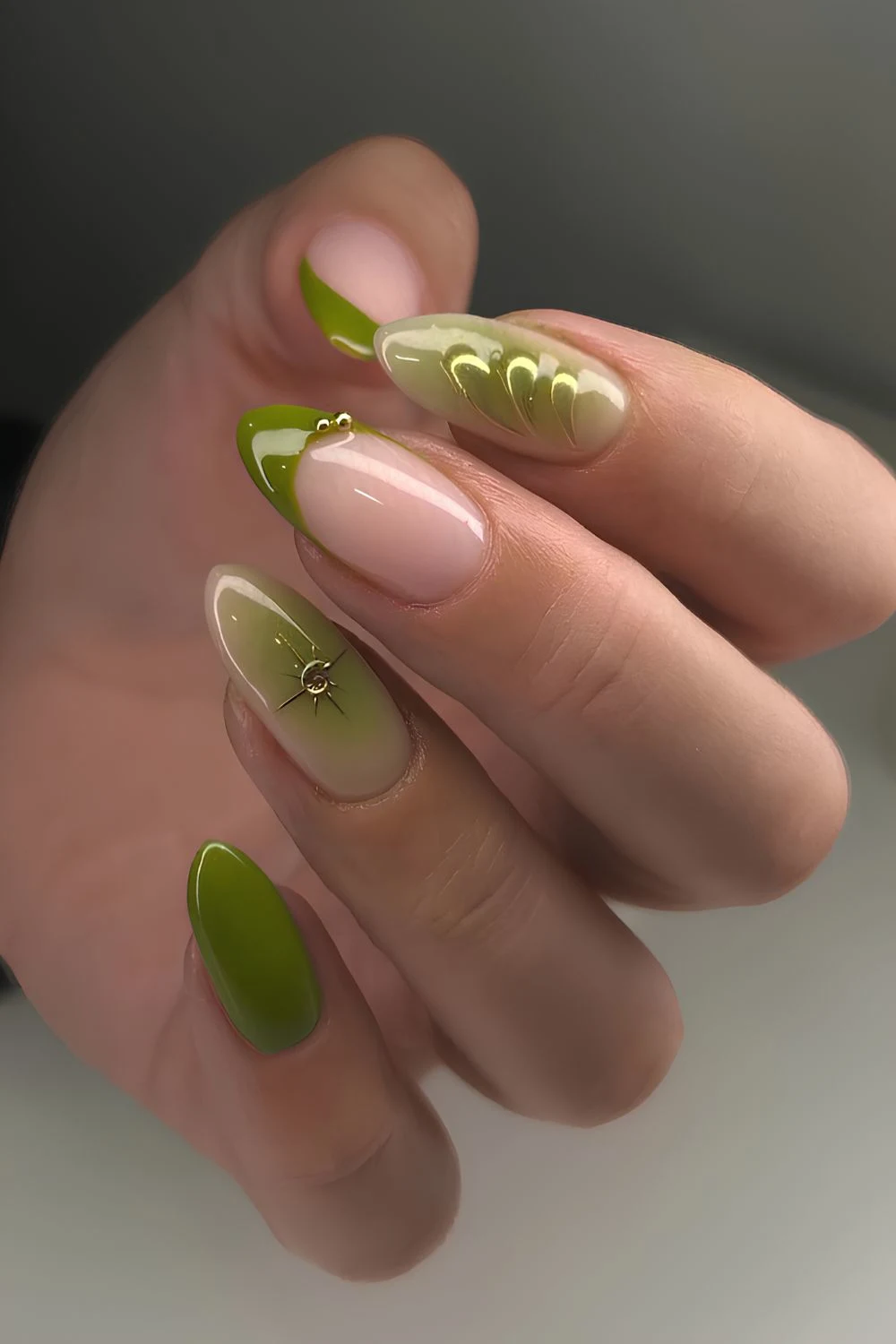 Olive green nails with rhinestones and gold details