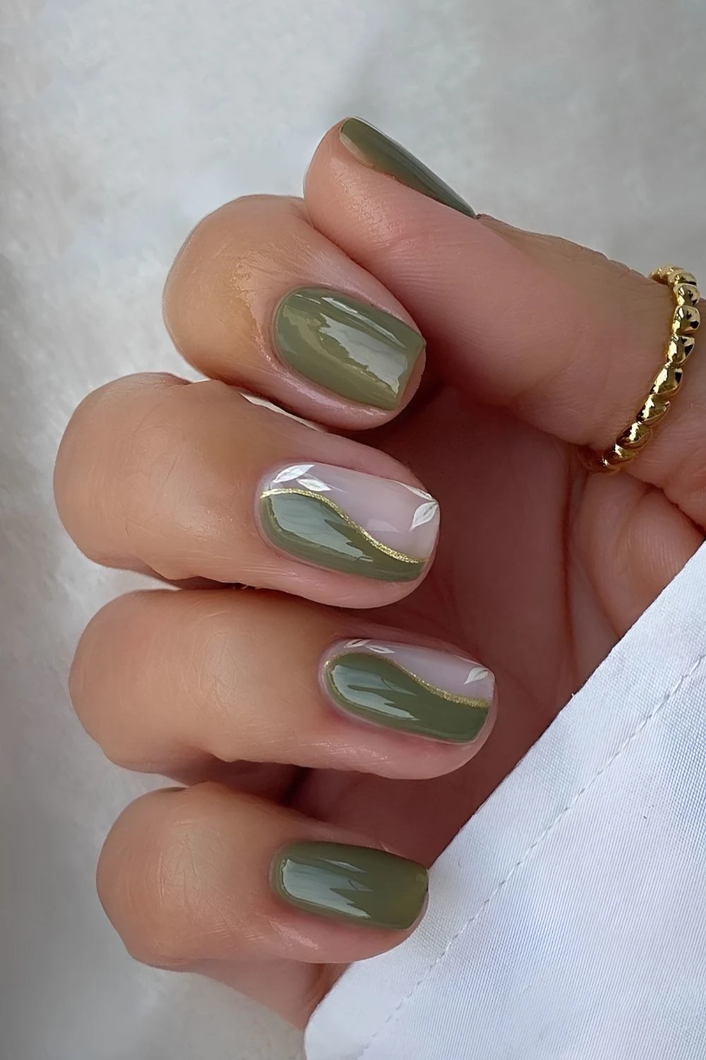 Olive green split swirl nails with gold accents
