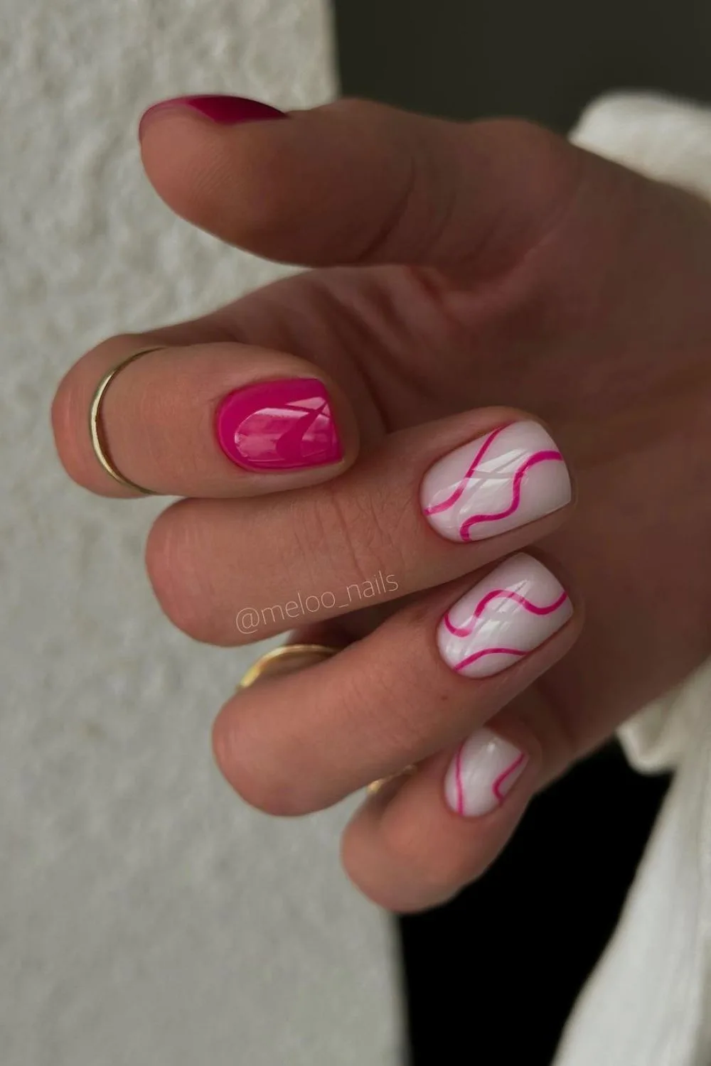 Pink and white nails with swirls