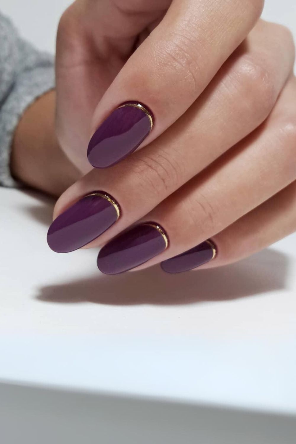 Plum nails with gold cuffs