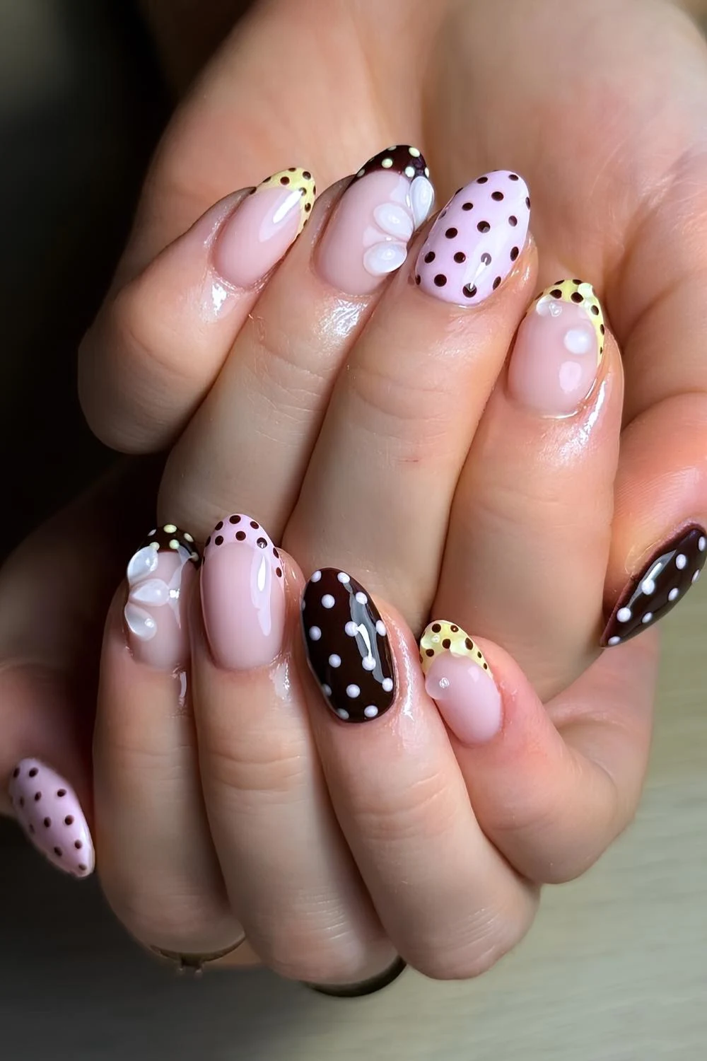 Polka dot nails in brown pink and yellow