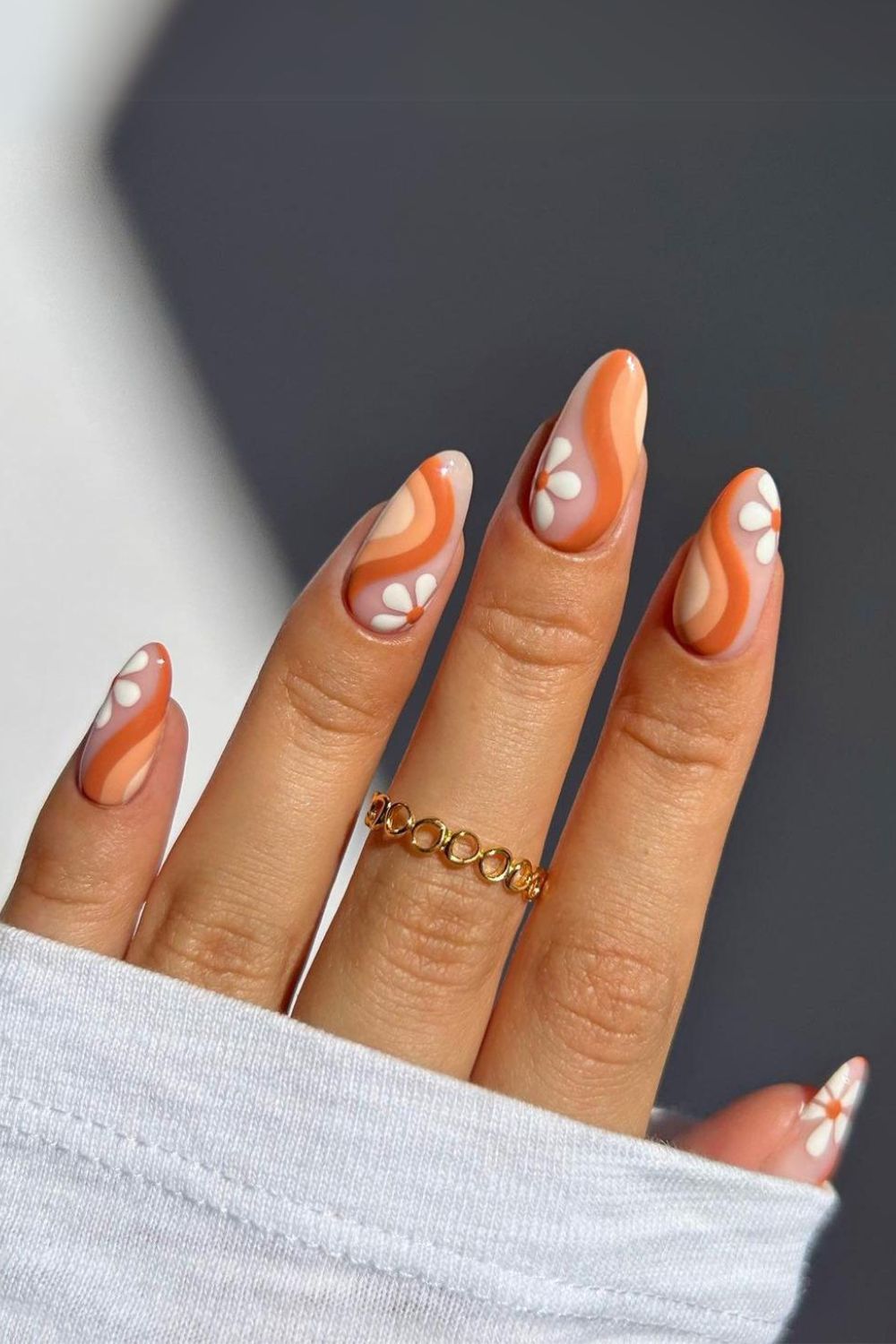 Retro orange nails with flowers and swirls