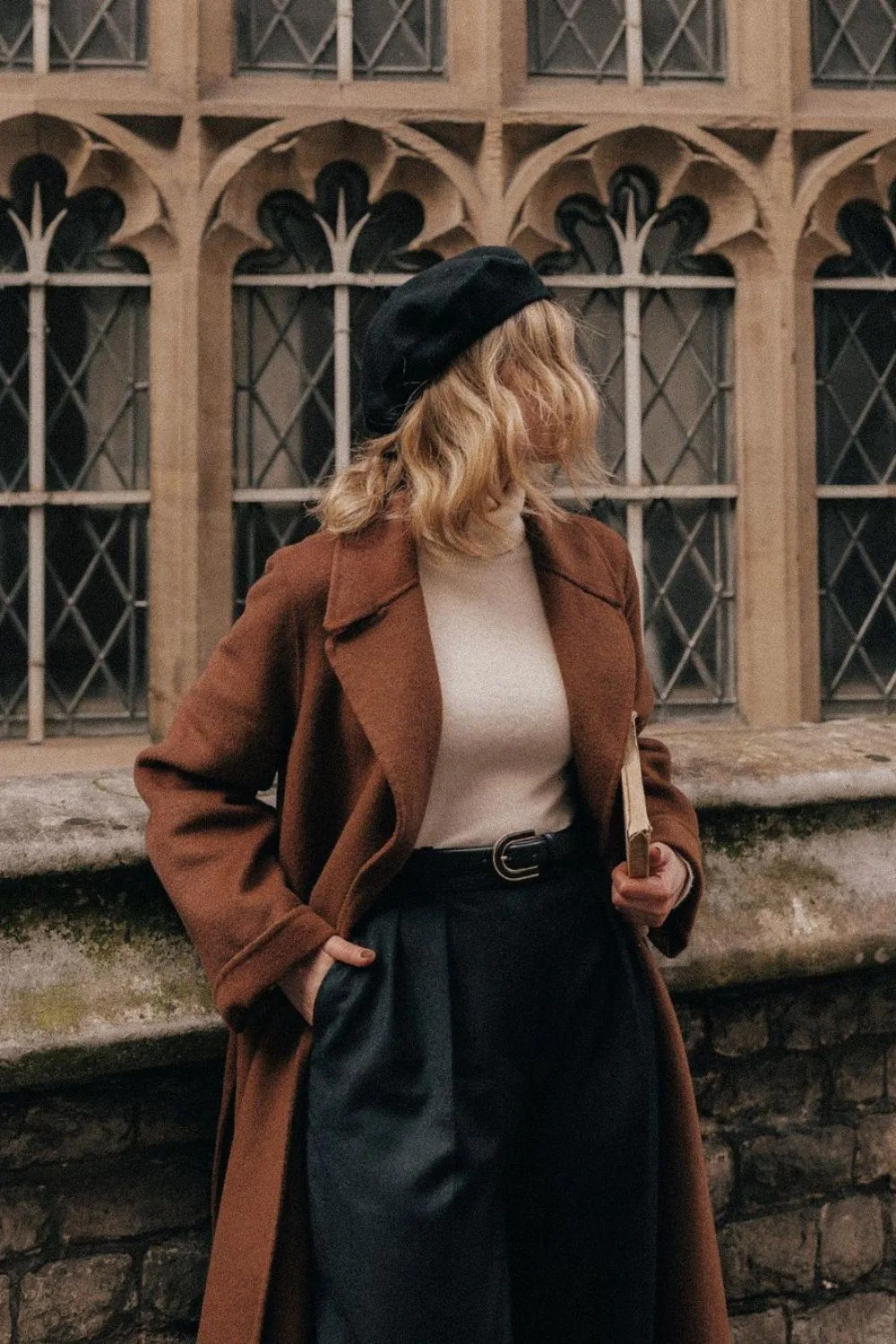 Rust coat with turtleneck, high-waisted trouses and beret