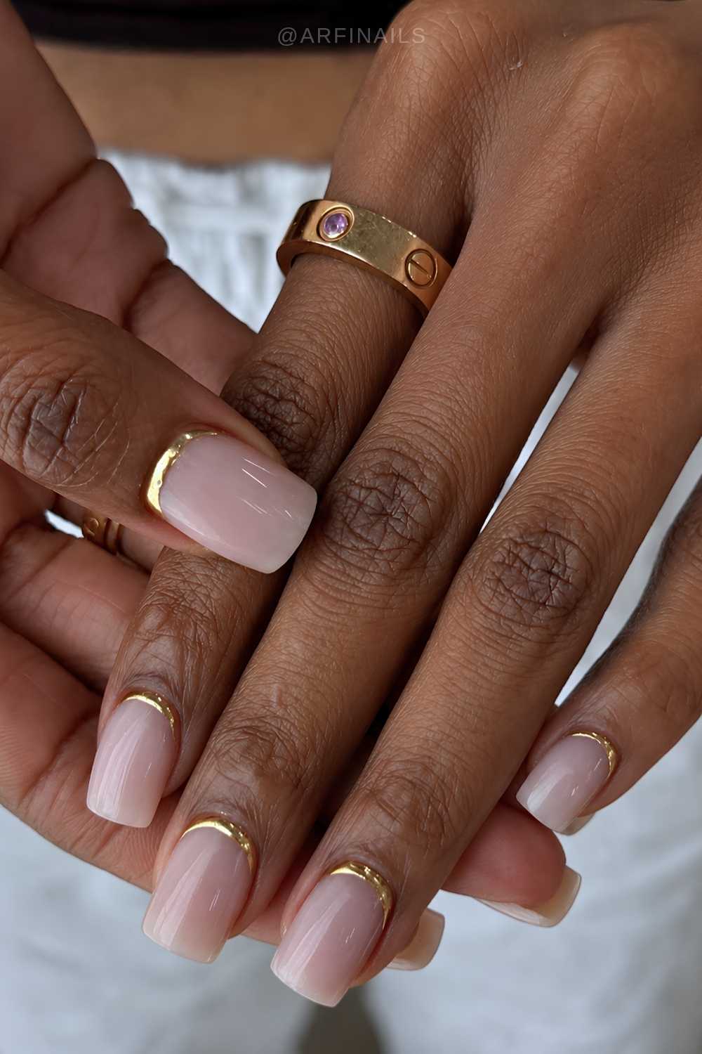 Short milky nails with gold accents