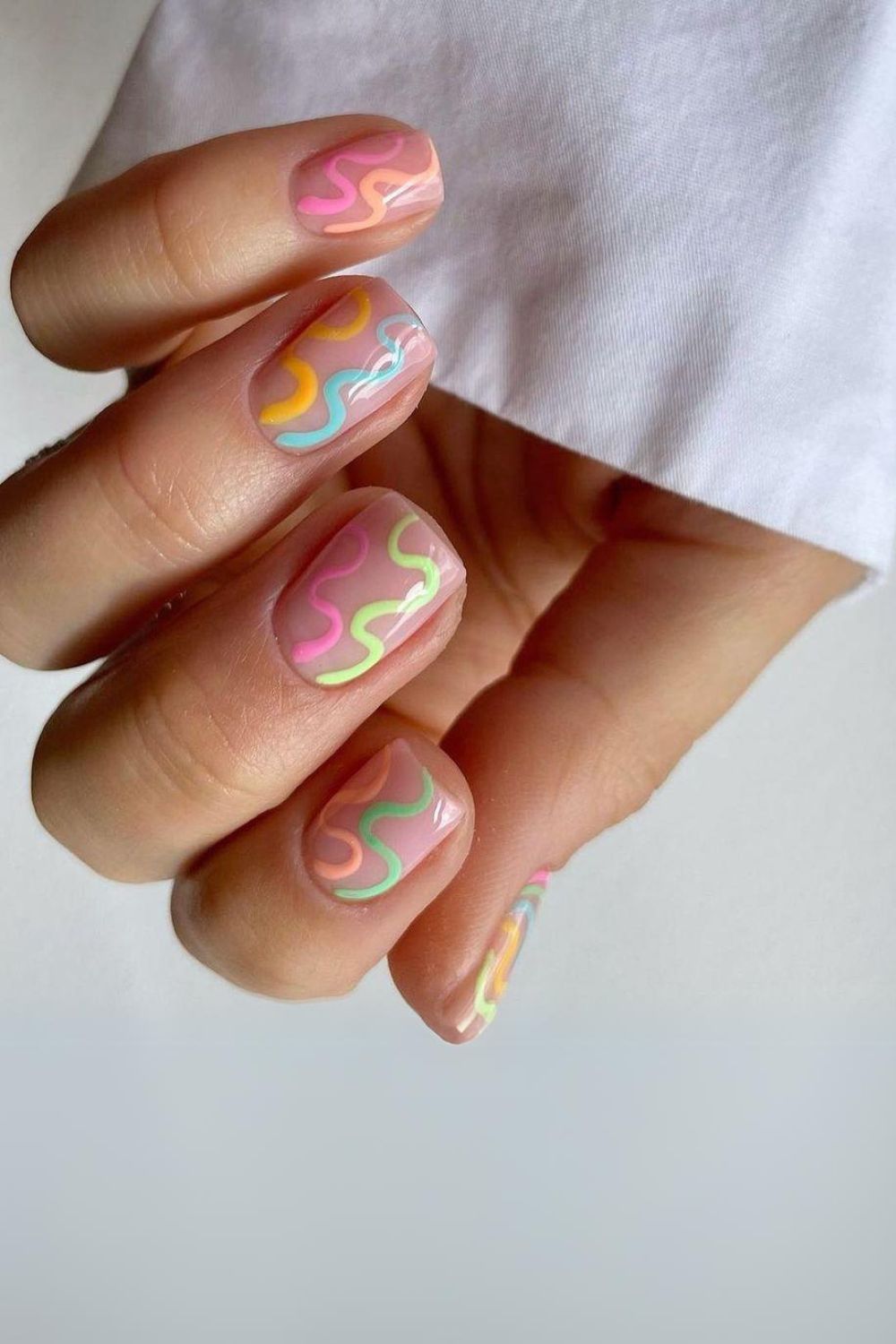 Short nude nails with colorful squiggles