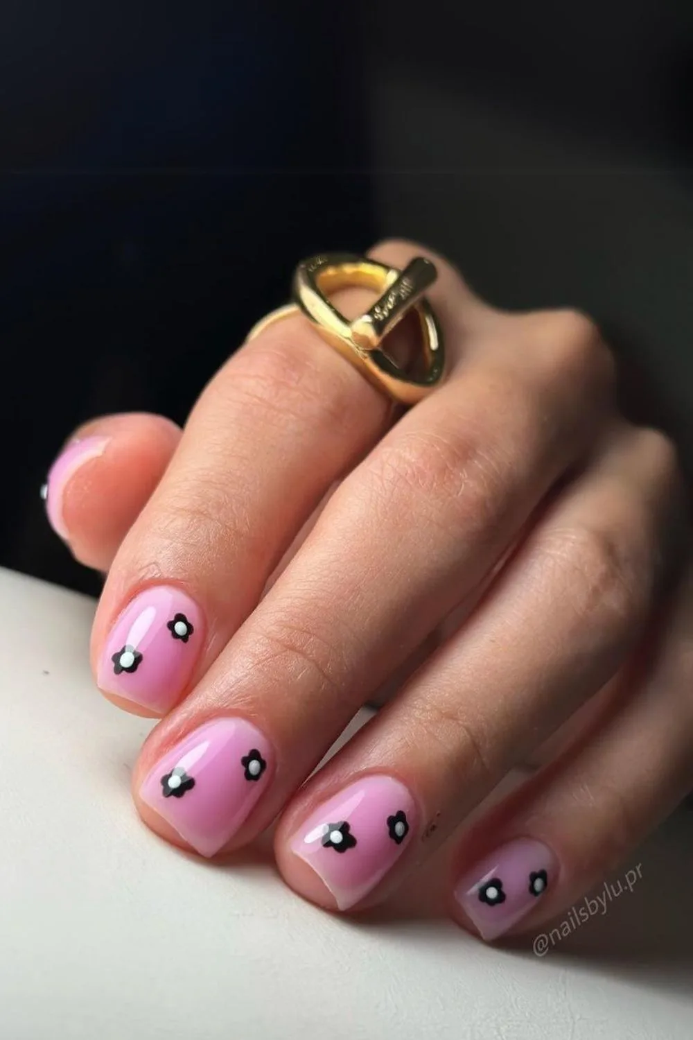 Short pink nails with black flowers