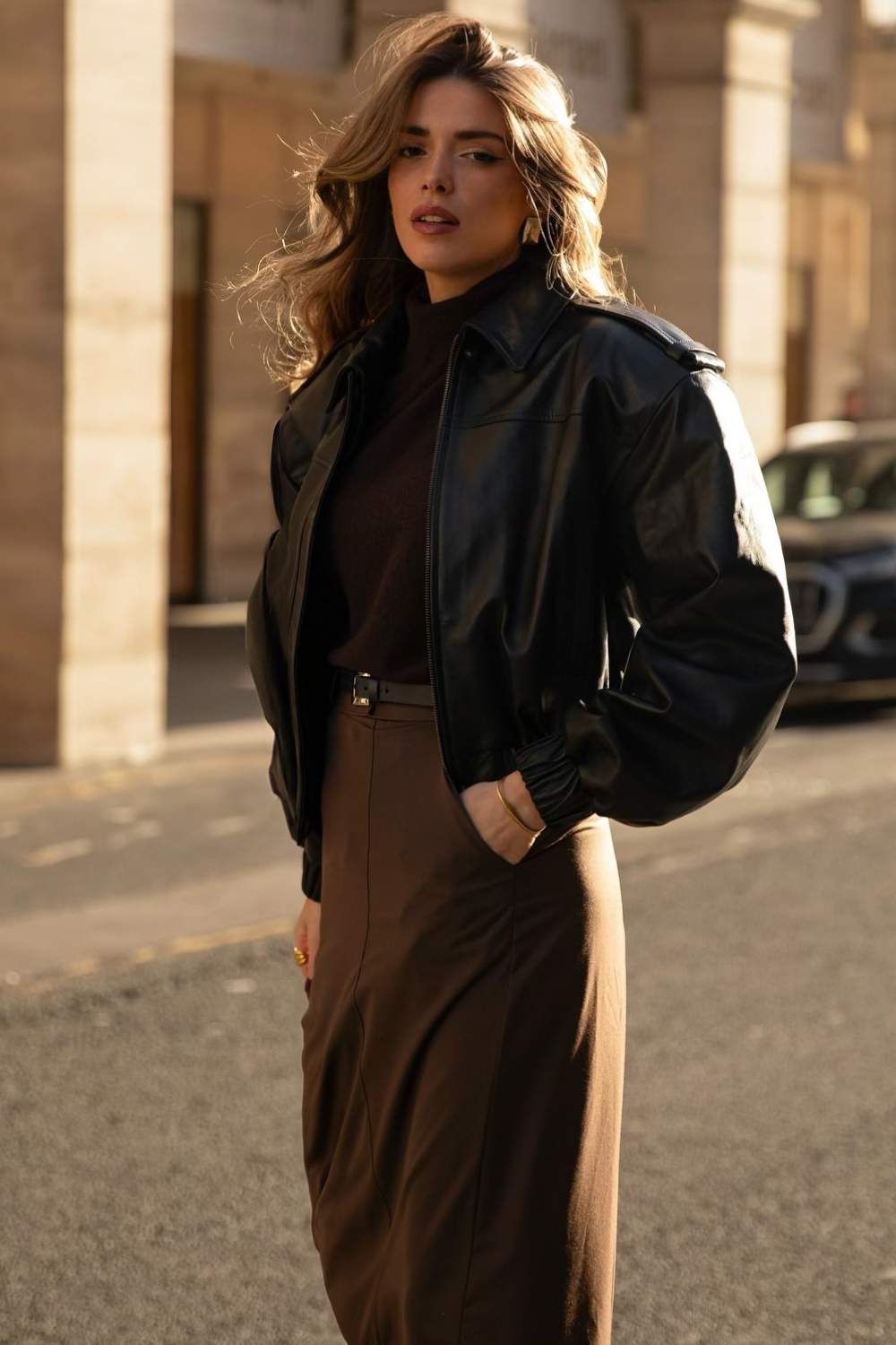 black leather jacket with brown turtleneck and brown midi skirt
