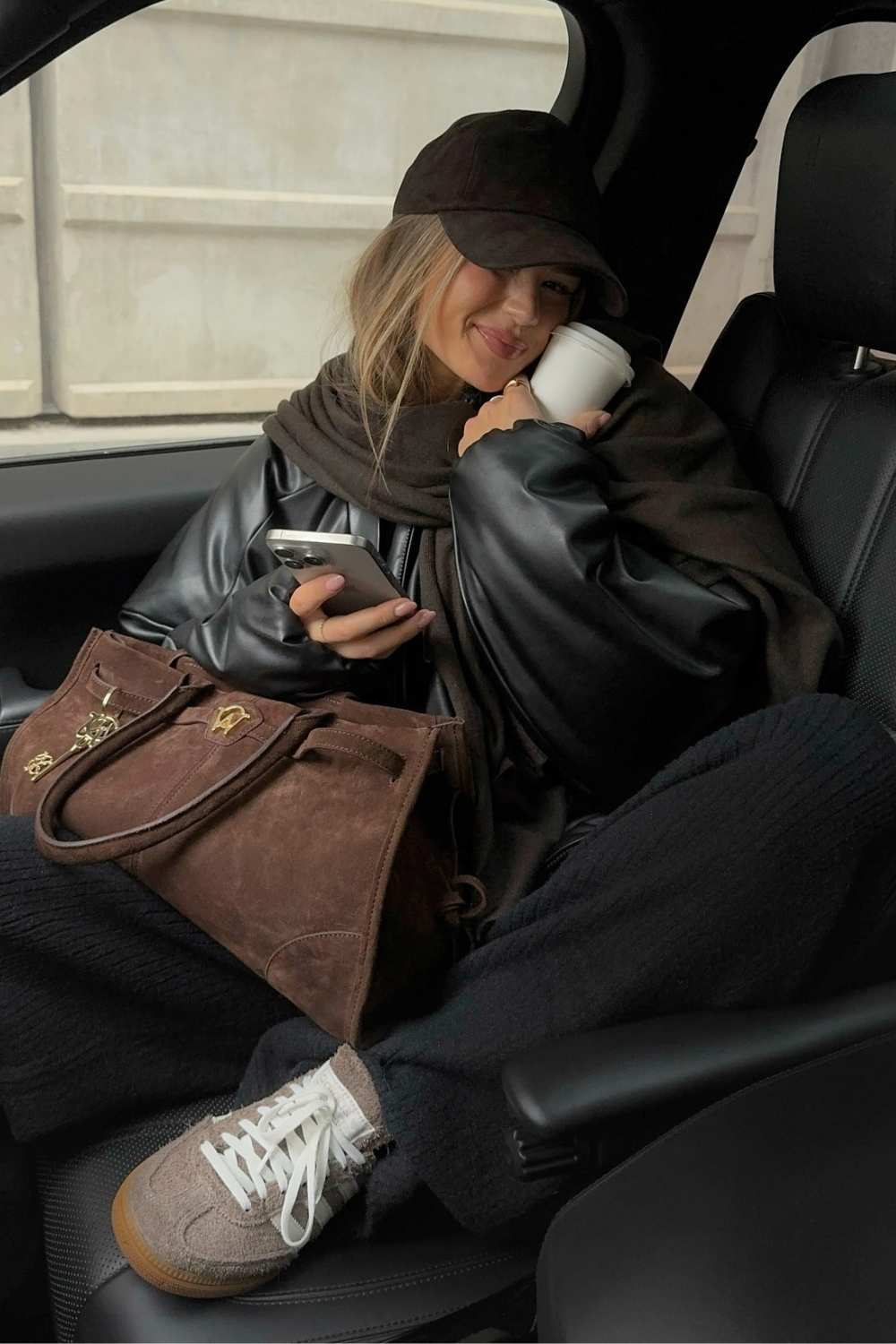 black leather jacket with sweatpants and brown scarf