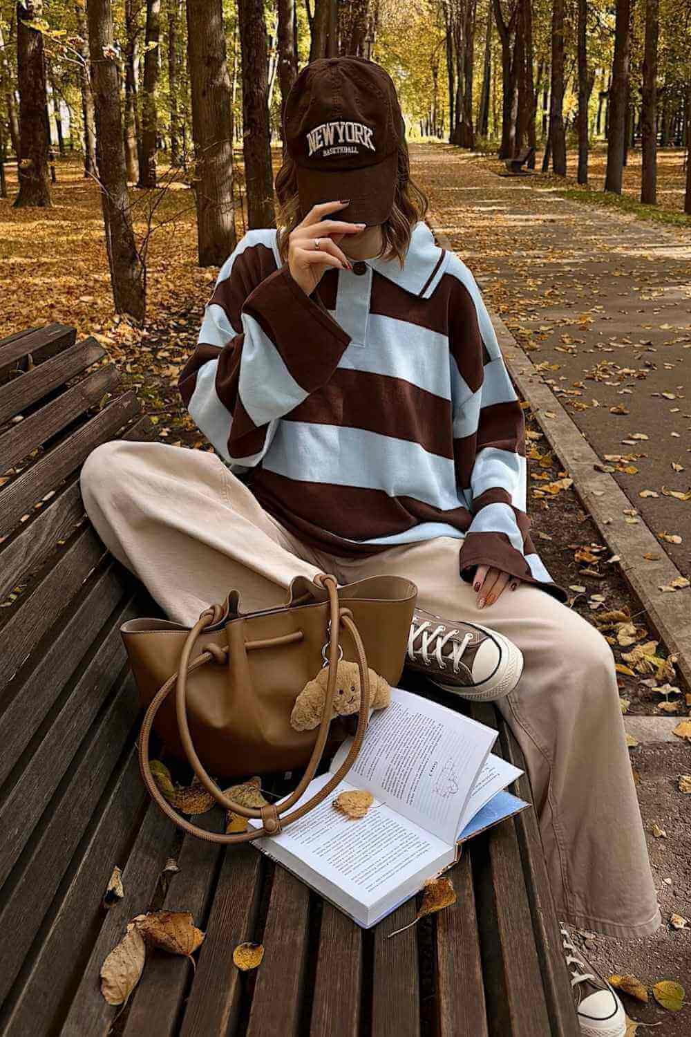 brown and blue rugby shirt with wide leg beige pants